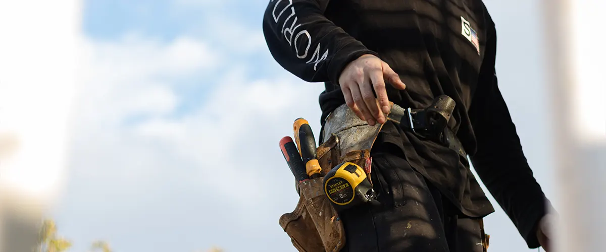 A licensed contractor with equipment and dressed in black