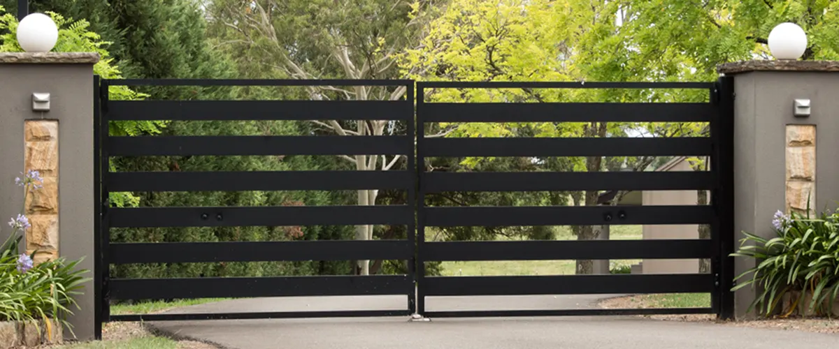 An aluminum black gate on a driveway