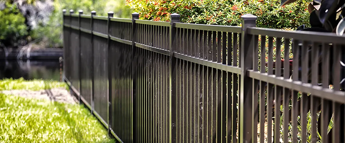Black aluminum fence and a patch of grass