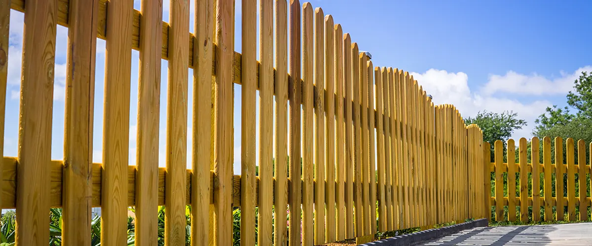Close up to a small wooden picket fence