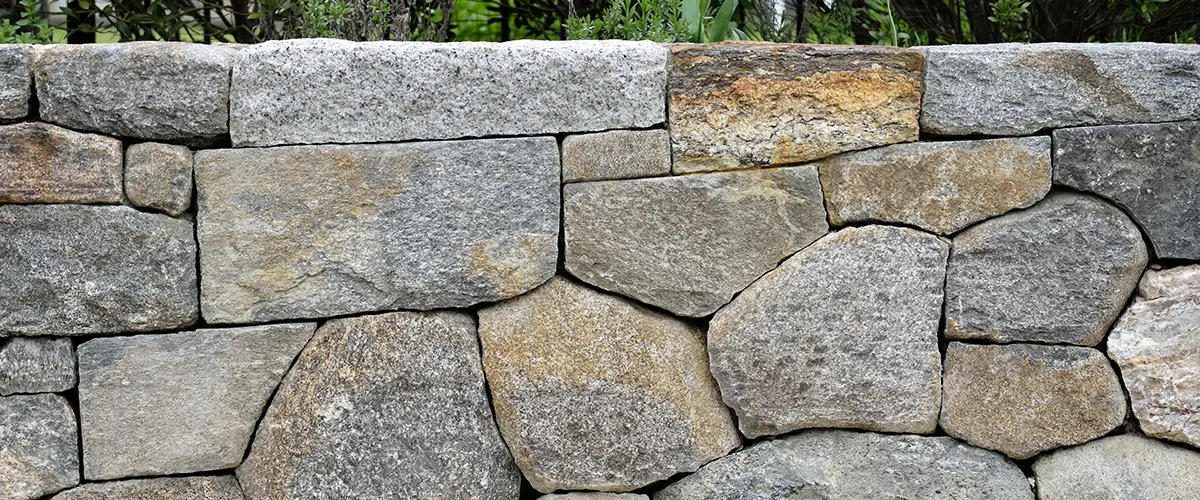 A close up with rocks perfectly matching each other on a retaining wall