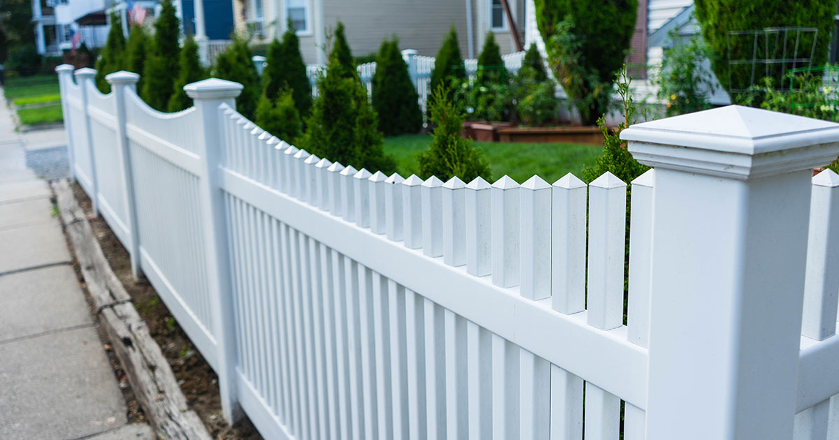 White picket fence with posts cap