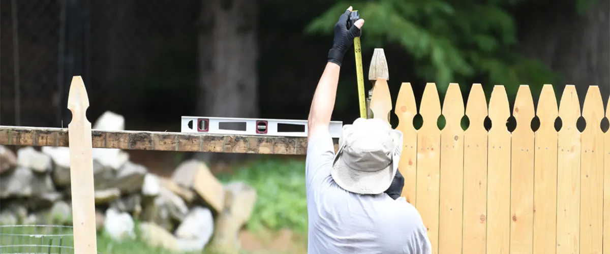 Men installing wood fence