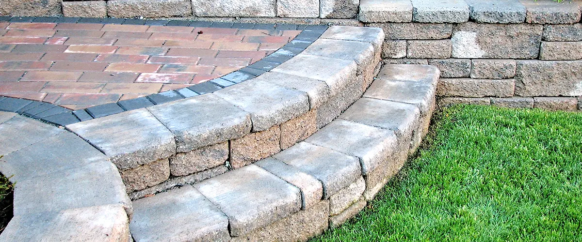 A couple of round stone stairs on stone walls