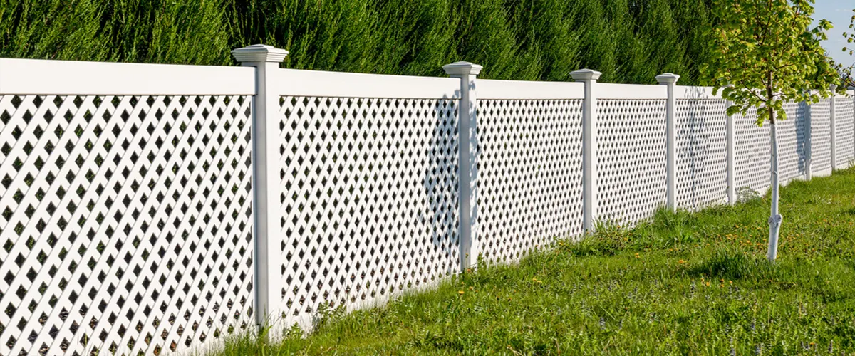 White fence and green background