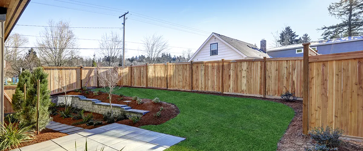 Wooden privacy fence with lawn