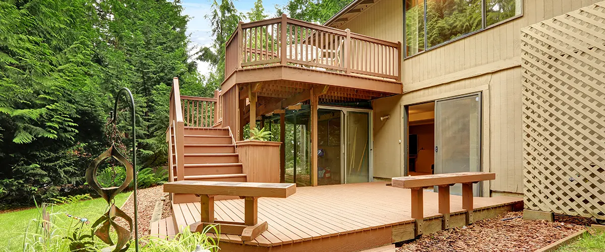 An elevated deck with two set of stairs with composite decking