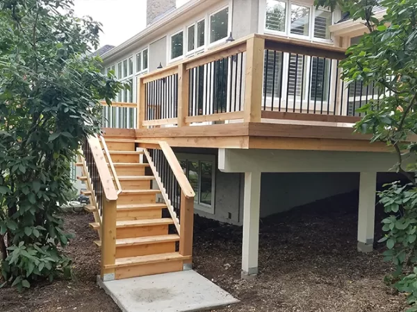 An elevated wood deck with aluminum railings